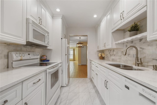 kitchen with recessed lighting, tasteful backsplash, white appliances, a sink, and white cabinets