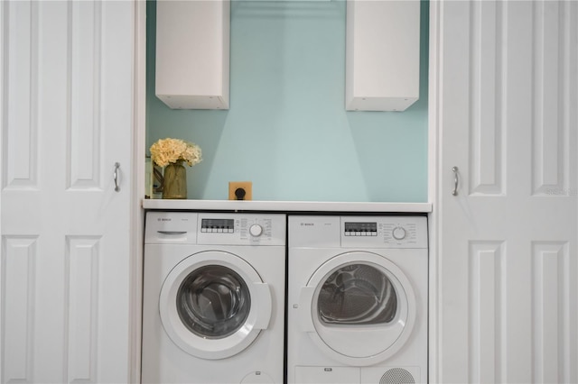 clothes washing area featuring washing machine and clothes dryer and laundry area