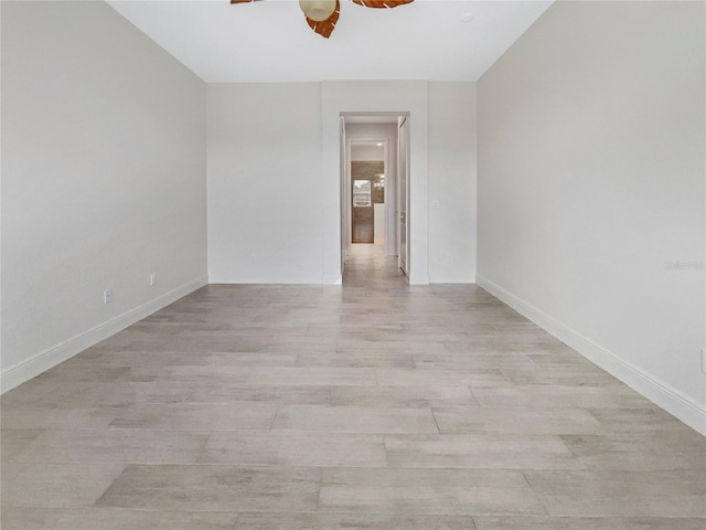 spare room featuring ceiling fan and light hardwood / wood-style flooring