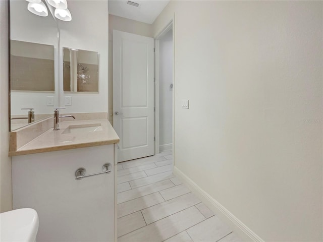 bathroom featuring tile patterned floors, vanity, and toilet