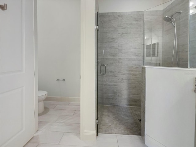 bathroom with walk in shower, tile patterned flooring, and toilet