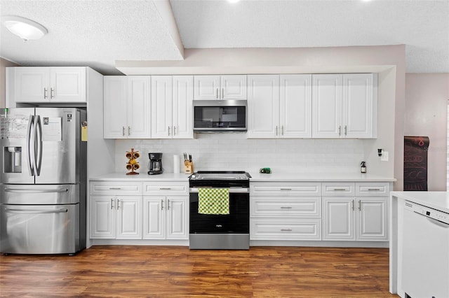 kitchen with white cabinets, backsplash, and stainless steel appliances