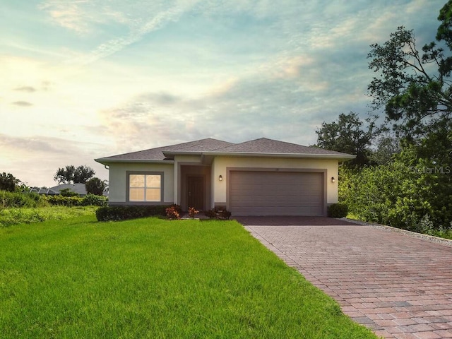 view of front of house with a garage and a front lawn