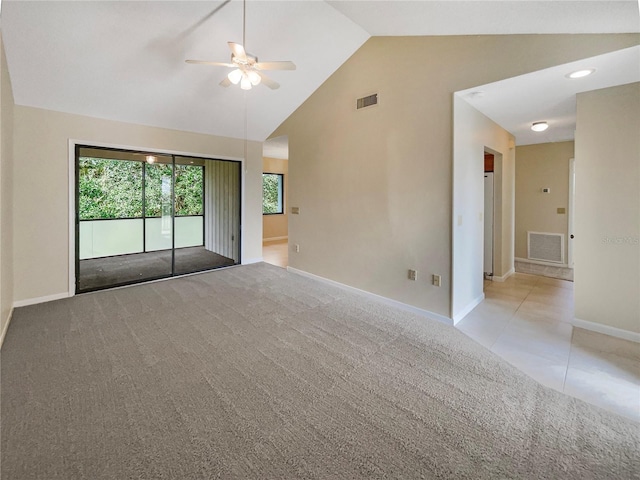 empty room featuring high vaulted ceiling, ceiling fan, and light colored carpet