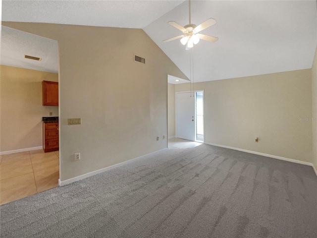 empty room with light carpet, lofted ceiling, and ceiling fan