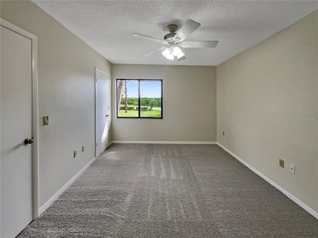 carpeted spare room with a textured ceiling and ceiling fan