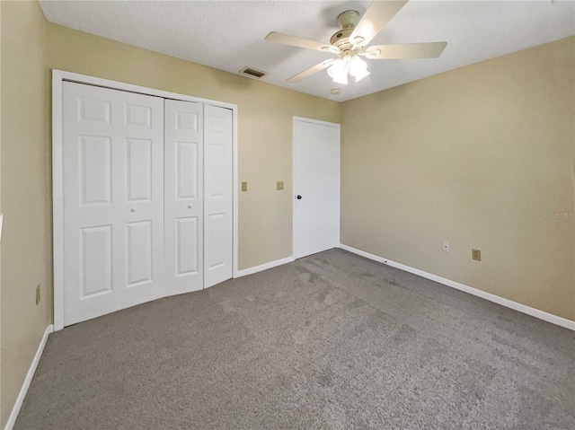 unfurnished bedroom with a closet, ceiling fan, and carpet floors