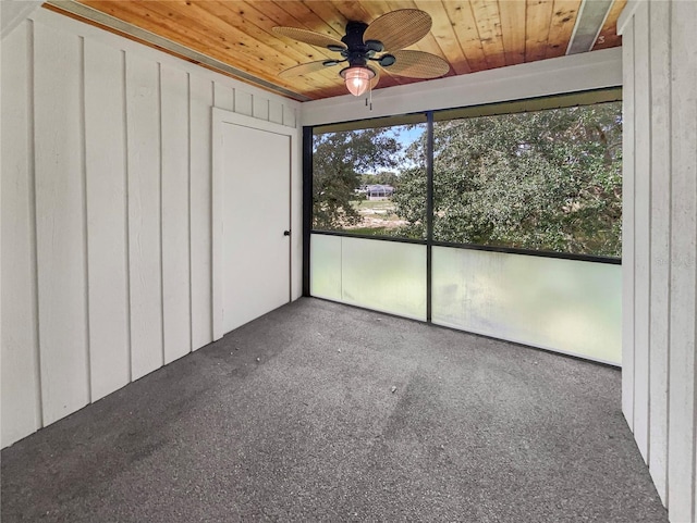 unfurnished sunroom with ceiling fan and wooden ceiling