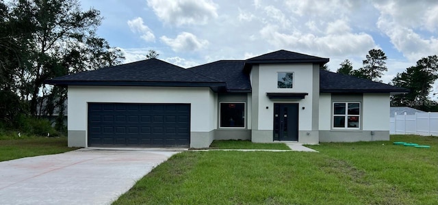 view of front facade with a front yard and a garage