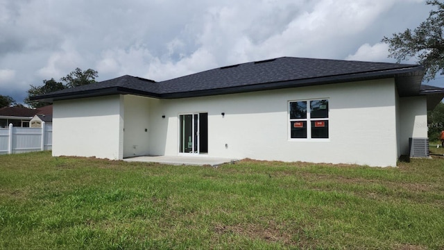 back of property featuring a patio and a yard