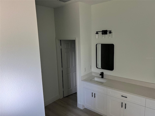 bathroom with vanity and hardwood / wood-style floors