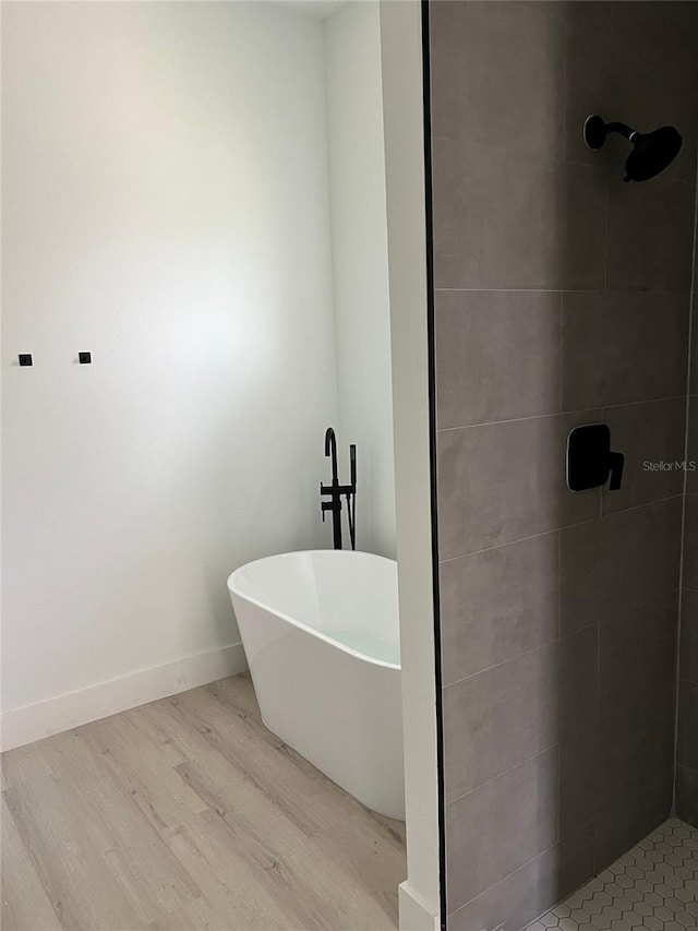 bathroom featuring hardwood / wood-style flooring and separate shower and tub