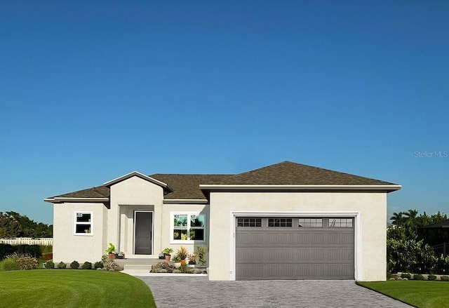 view of front of home with a garage and a front lawn