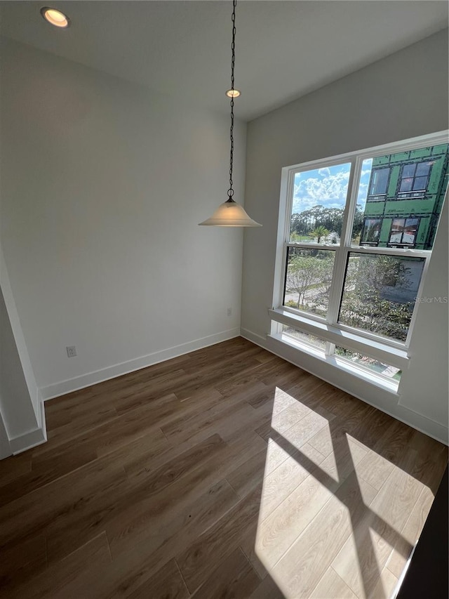 unfurnished dining area featuring dark hardwood / wood-style floors