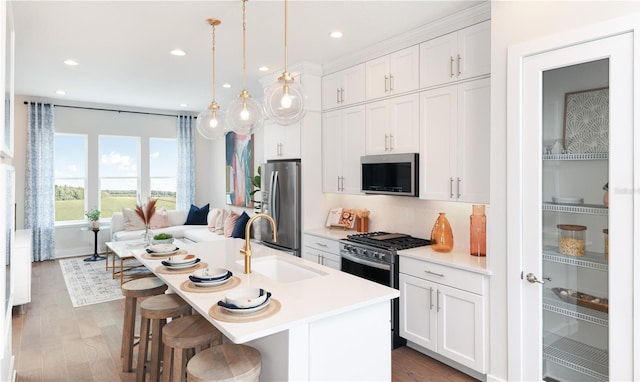 2110 Whitney Marsh Aly, Orlando, FL 32804 - kitchen featuring stainless steel appliances, a sink, light countertops, white cabinetry, and recessed lighting