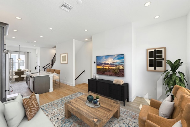 2110 Whitney Marsh Aly, Orlando, FL 32804 - living room featuring recessed lighting, light wood-style floors, stairs, and baseboards