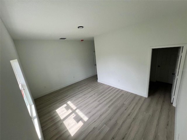 unfurnished room with light hardwood / wood-style floors