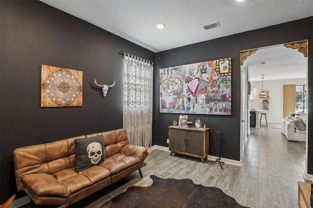 living room with a healthy amount of sunlight and hardwood / wood-style floors