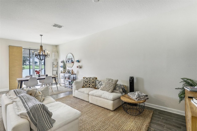 living room featuring dark hardwood / wood-style flooring and a chandelier