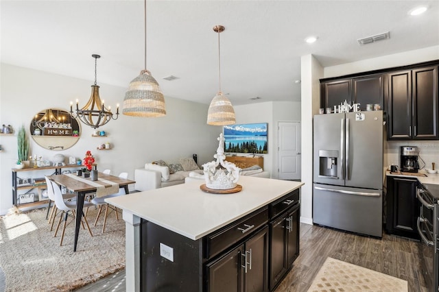 kitchen featuring hanging light fixtures, tasteful backsplash, stainless steel fridge with ice dispenser, dark hardwood / wood-style floors, and a center island