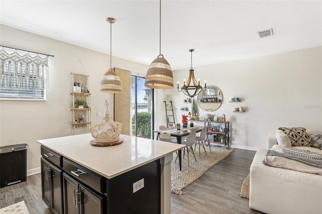 kitchen featuring light wood-type flooring, hanging light fixtures, and a kitchen island