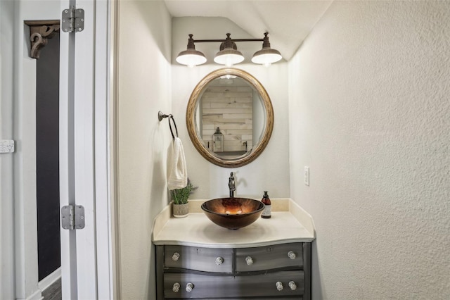 bathroom with vanity and vaulted ceiling