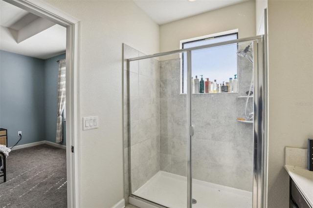 bathroom with a shower with door and vanity