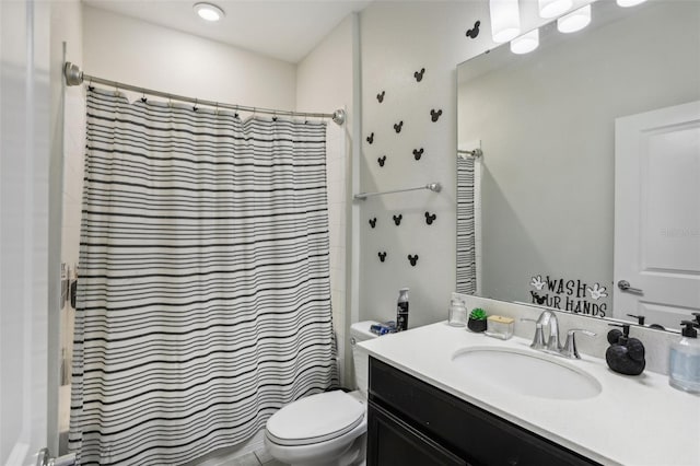 bathroom with walk in shower, vanity, and toilet