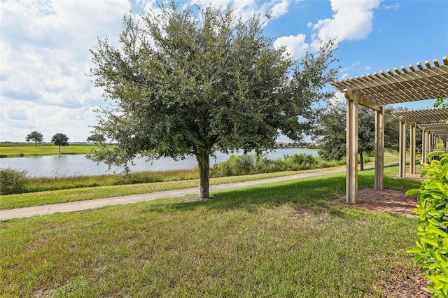 view of yard with a pergola and a water view