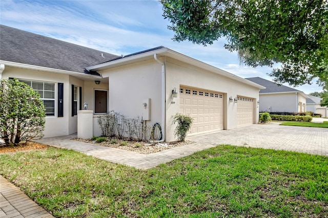 view of side of property with a yard and a garage