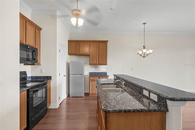 kitchen with dark hardwood / wood-style floors, sink, hanging light fixtures, black appliances, and ornamental molding