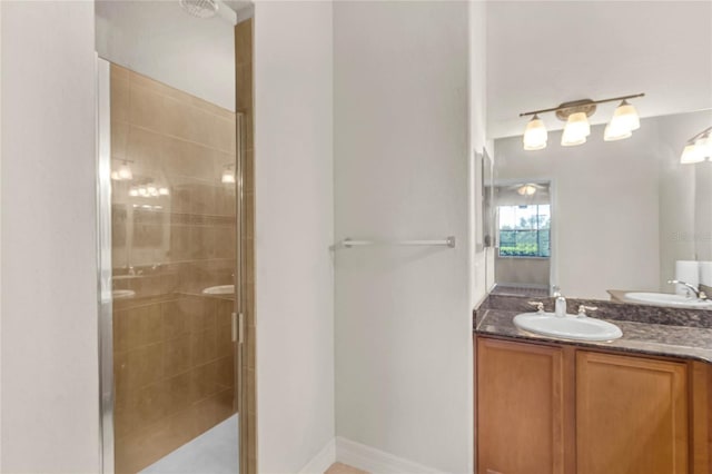 bathroom with walk in shower and vanity