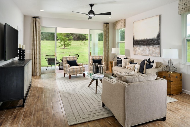 living room featuring ceiling fan, hardwood / wood-style floors, and a healthy amount of sunlight