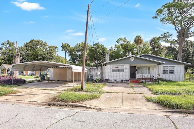 view of front of home with covered porch and a carport