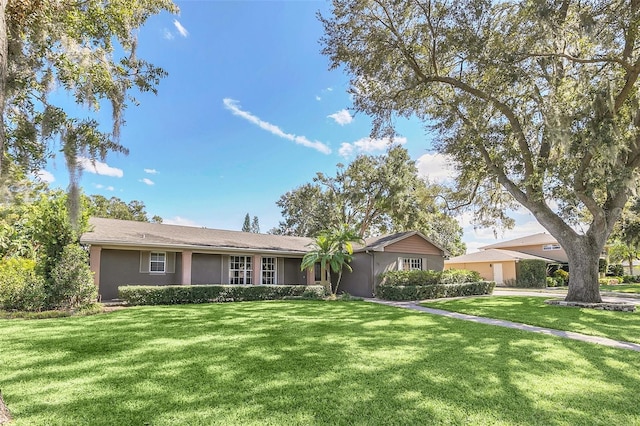 single story home featuring a front lawn