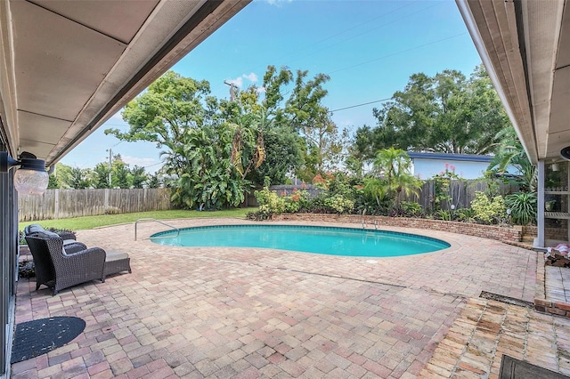 view of swimming pool with a patio