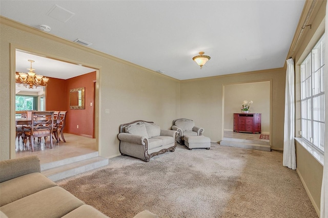 living room featuring crown molding, a chandelier, and carpet flooring