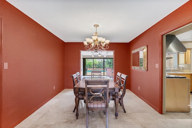 dining area featuring a notable chandelier and sink