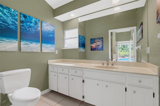 bathroom with vanity, toilet, and tile patterned flooring