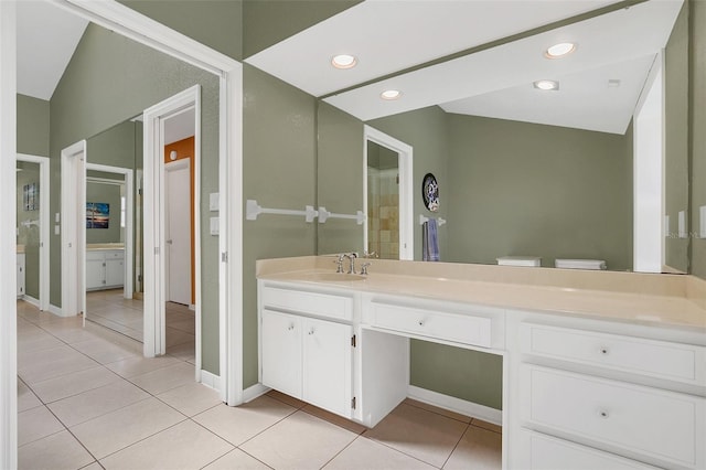 bathroom with vanity, toilet, and tile patterned flooring