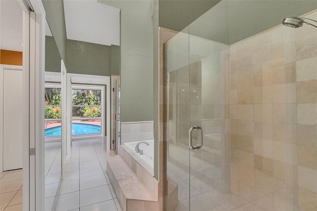 bathroom featuring independent shower and bath and tile patterned flooring