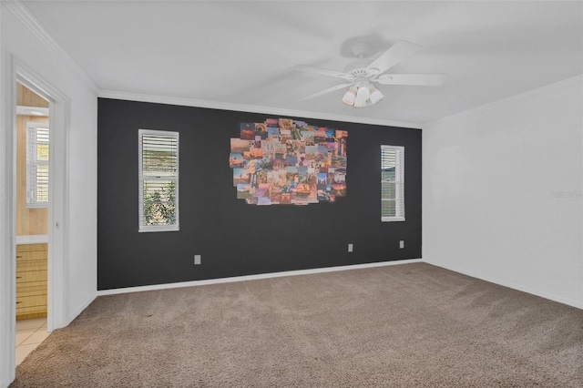 empty room with light carpet, ornamental molding, and ceiling fan