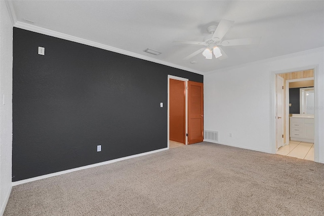 empty room with ceiling fan, ornamental molding, and light colored carpet