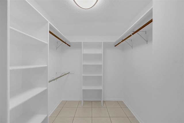 spacious closet featuring light tile patterned floors