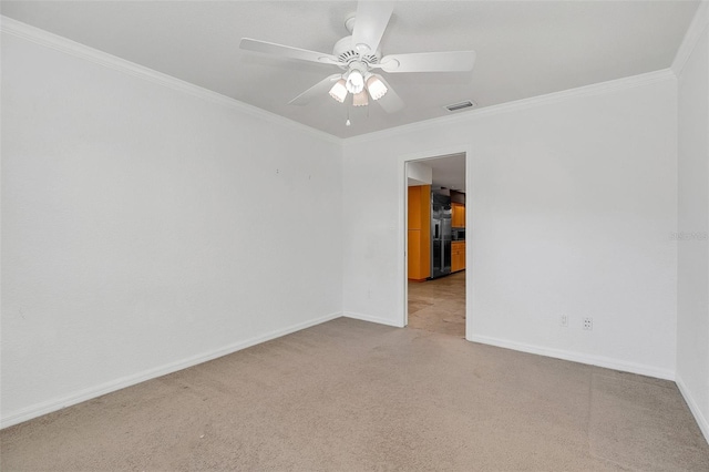 carpeted spare room with crown molding and ceiling fan