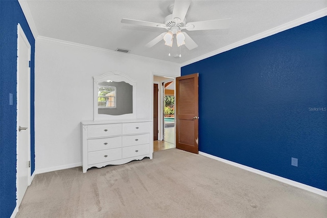 unfurnished bedroom with ornamental molding, light colored carpet, and ceiling fan