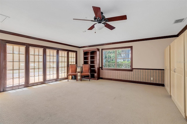 unfurnished room featuring ornamental molding, french doors, light colored carpet, and ceiling fan