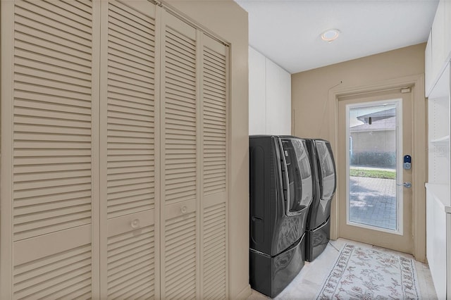 clothes washing area featuring separate washer and dryer