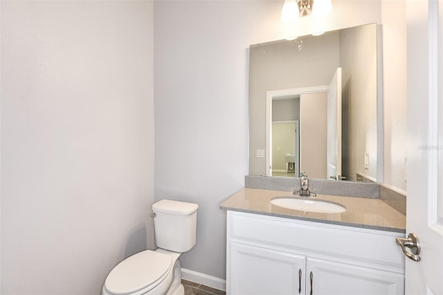 bathroom with vanity, toilet, and tile patterned floors