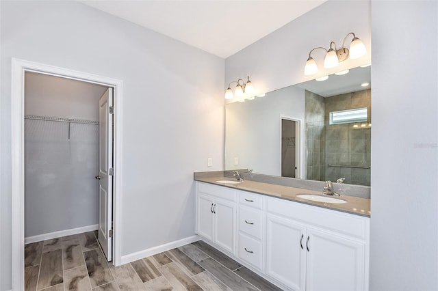 bathroom featuring wood-type flooring, an enclosed shower, and vanity